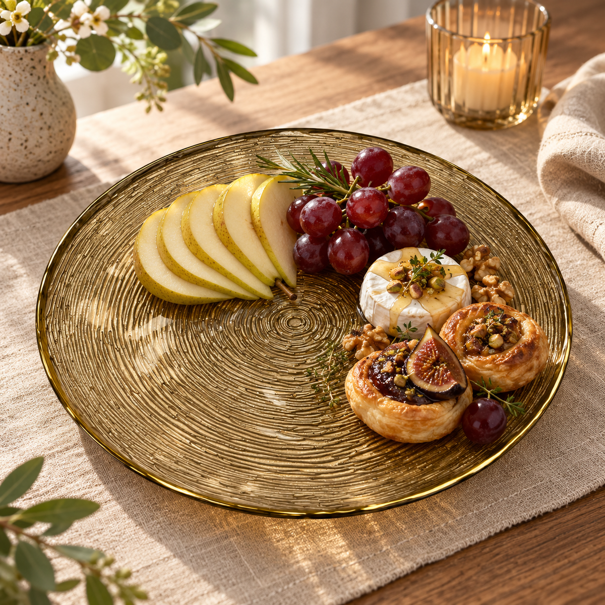 Amber tree-ring glass serving plate styled with fruit and appetizers