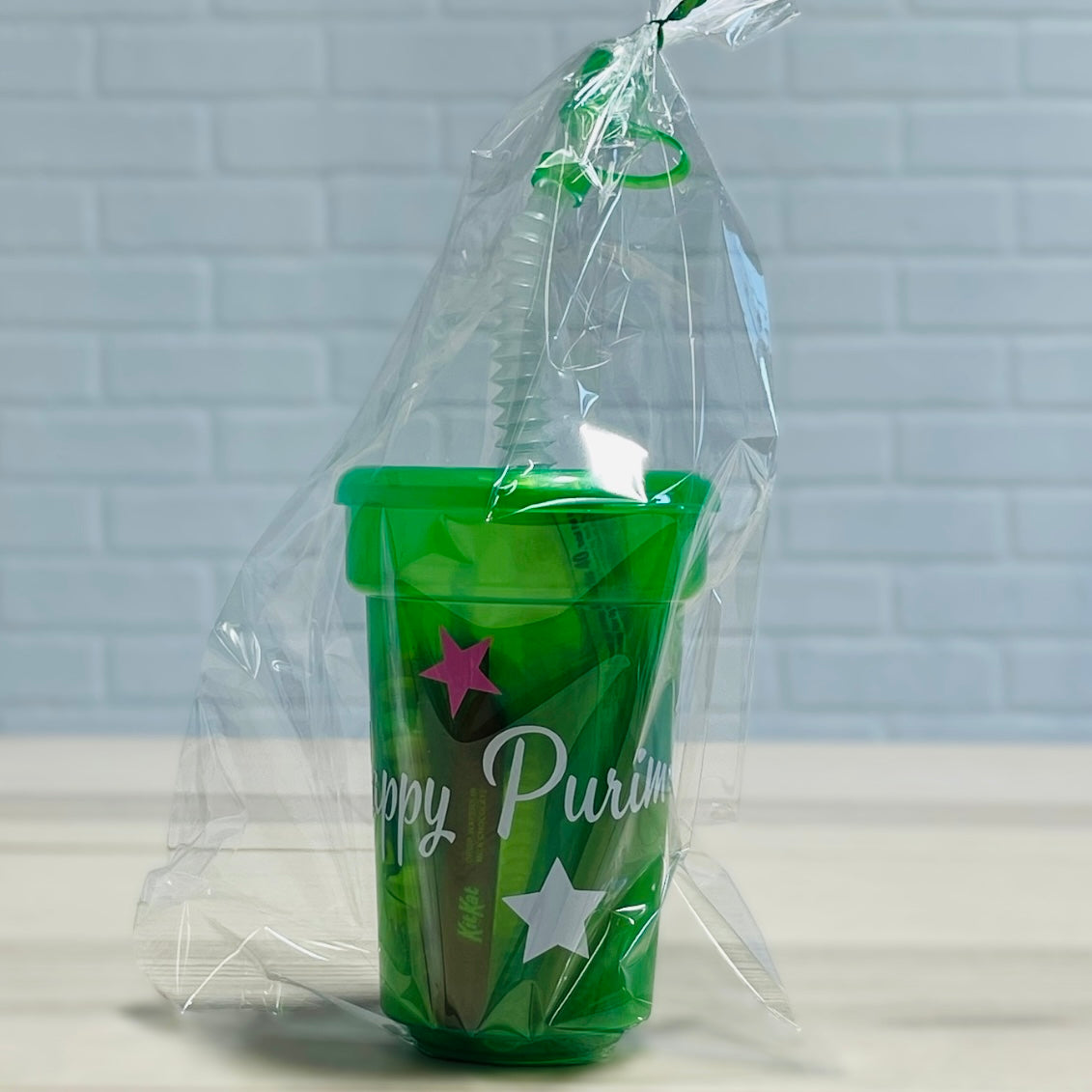 Purim kids mishloach manot tons of candies in a reusable plastic cup with strew