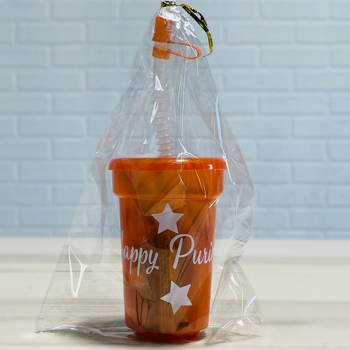 Purim kids mishloach manot tons of candies in a reusable plastic cup with strew