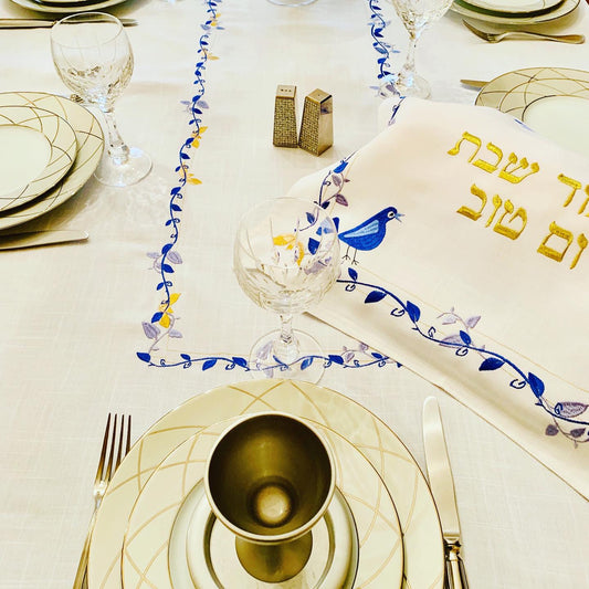 The Blue Bird Tablecloth Embroidered on Pure White Linen. Matching Challah Cover is available