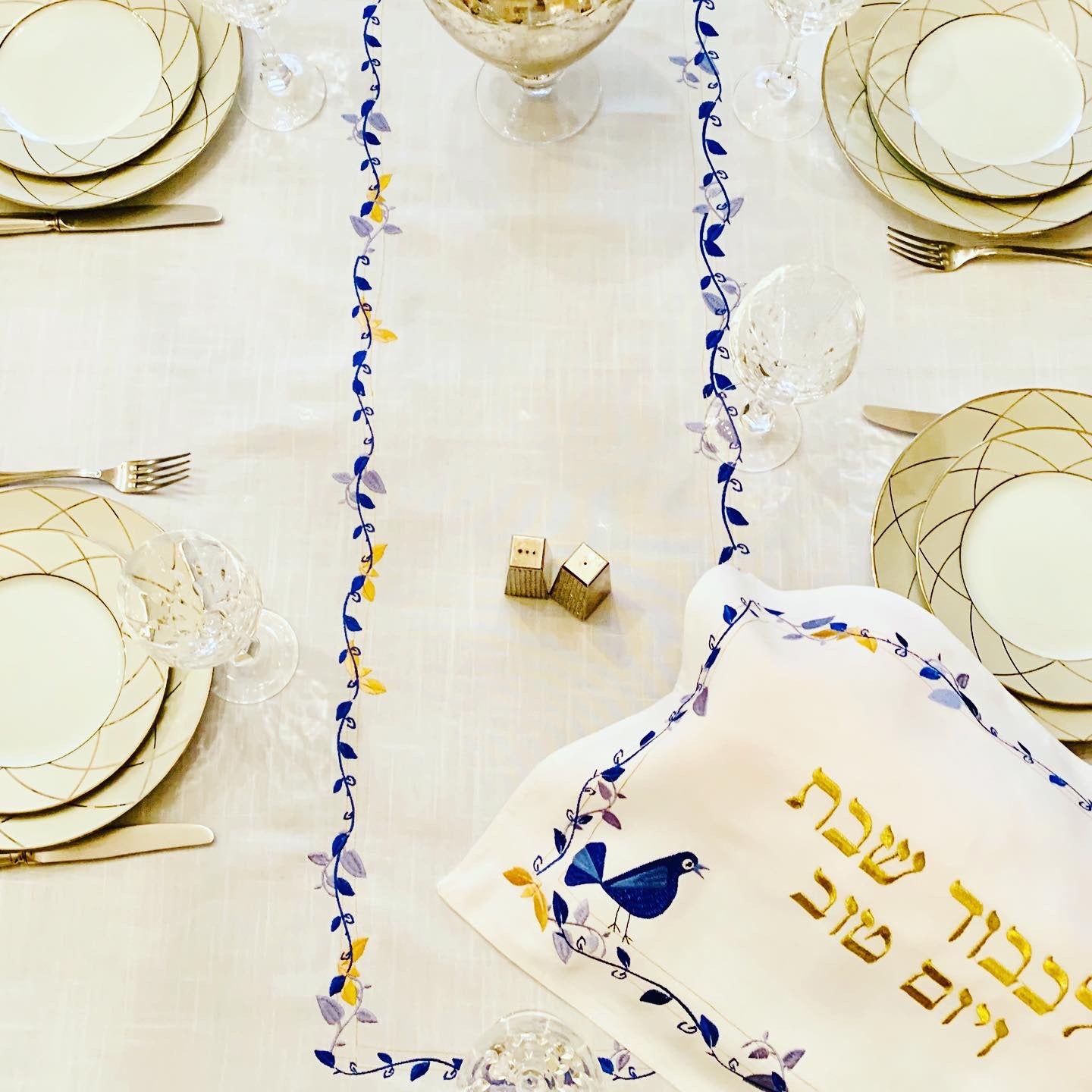 The Blue Bird Tablecloth Embroidered on Pure White Linen. Matching Challah Cover is available