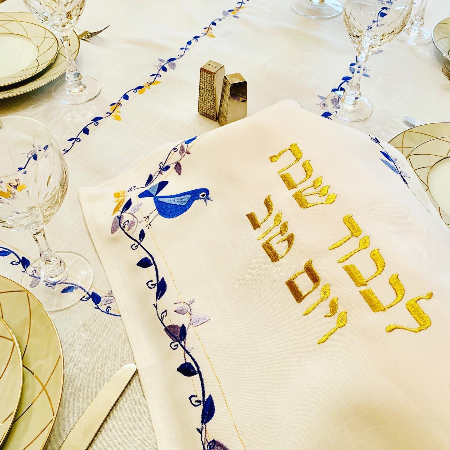 The Blue Bird Tablecloth Embroidered on Pure White Linen. Matching Challah Cover is available