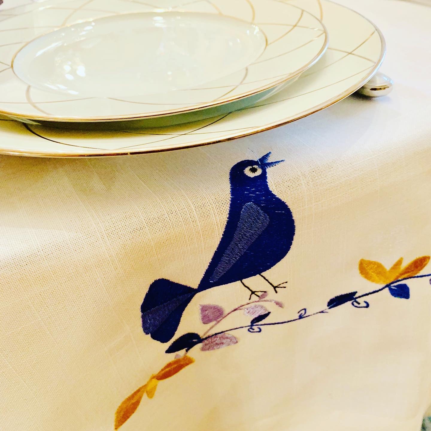 The Blue Bird Tablecloth Embroidered on Pure White Linen. Matching Challah Cover is available