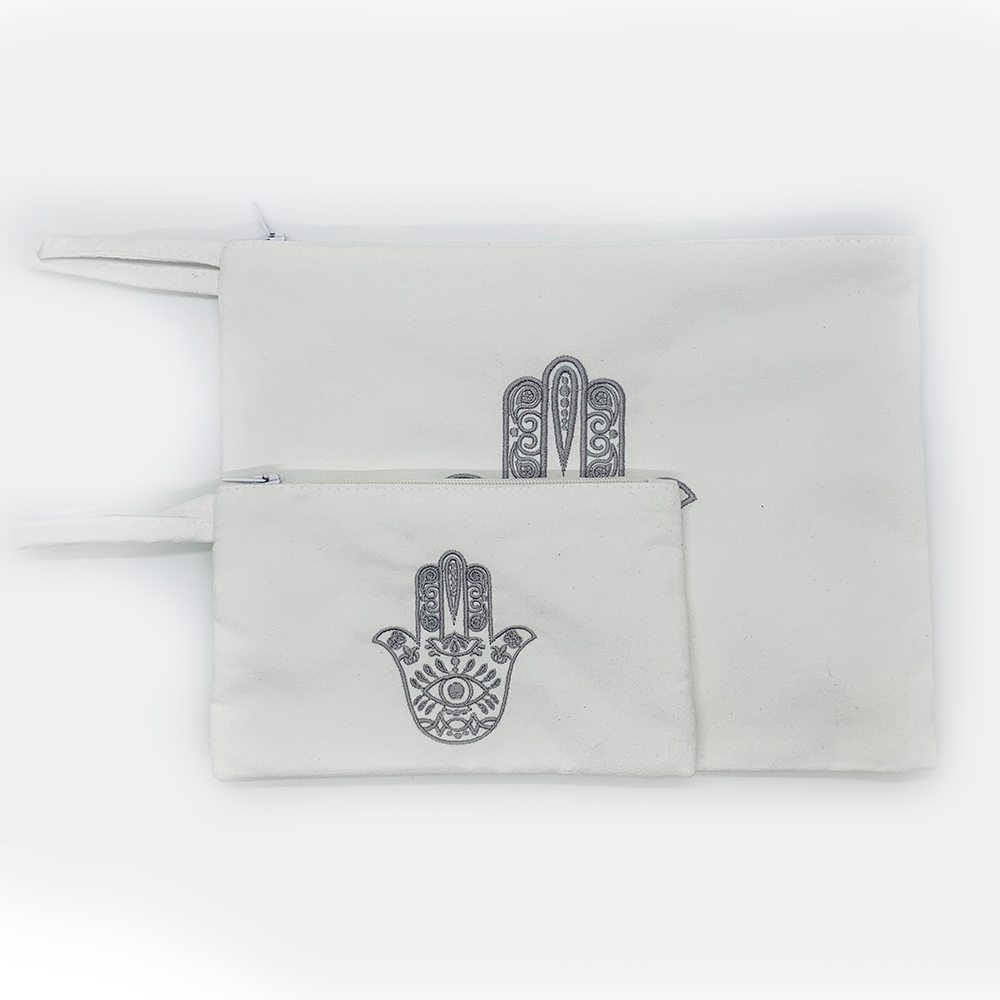 Embroidered hamsa Suede black or white bag zipper closure. Satin lining.