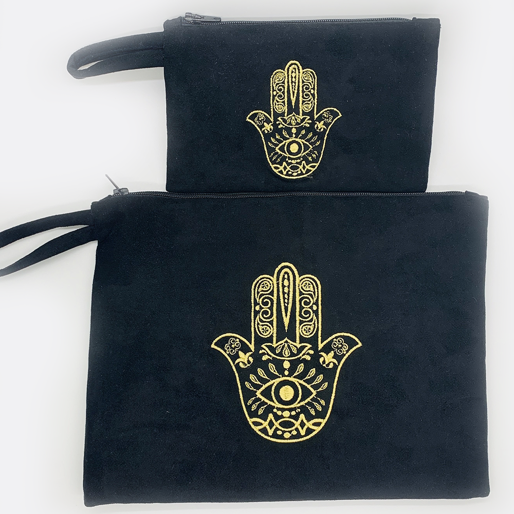 Embroidered hamsa Suede black or white bag zipper closure. Satin lining.