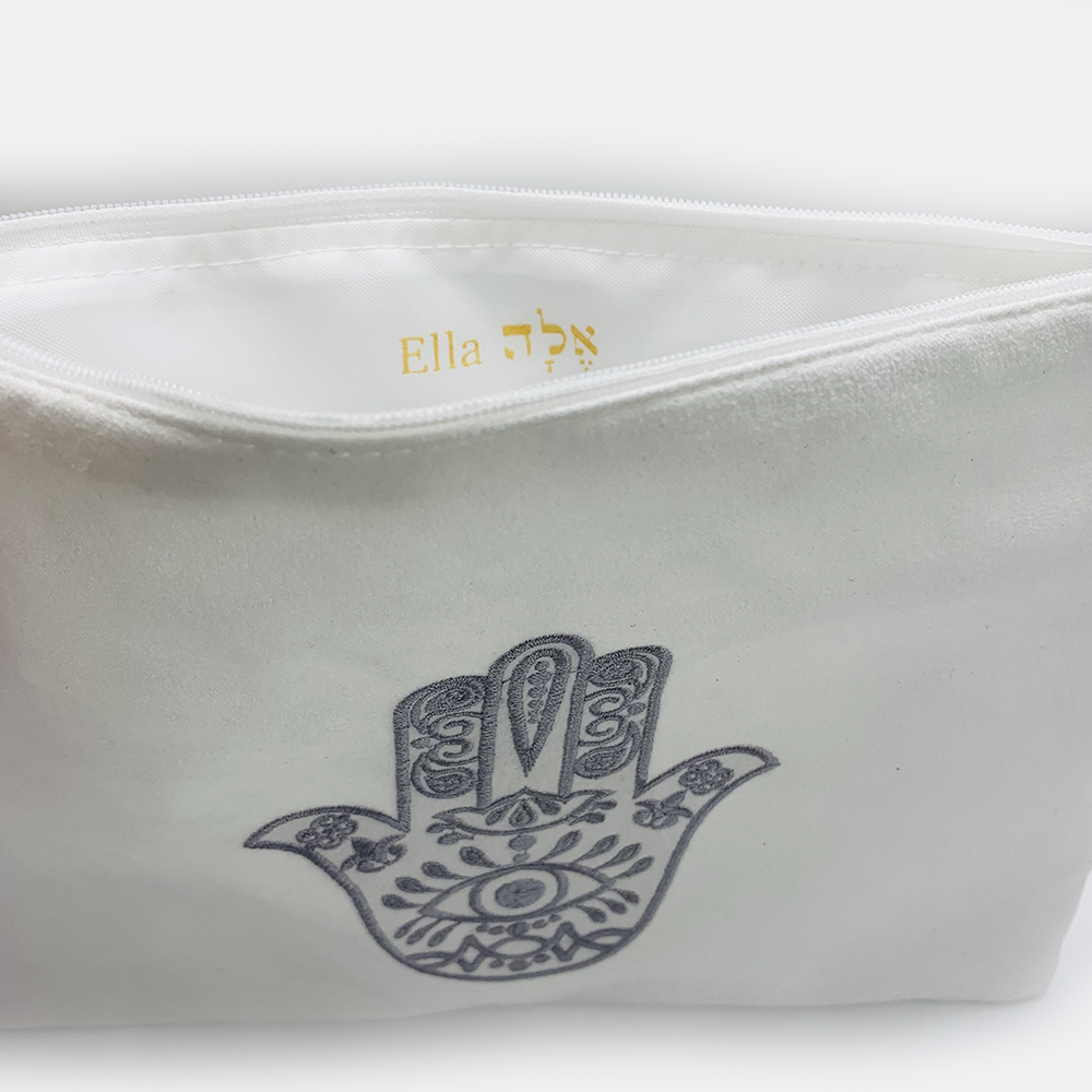 Embroidered hamsa Suede black or white bag zipper closure. Satin lining.