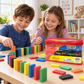 Children ages six and up playing with colorful EVA foam dominoes beside the red zippered storage case