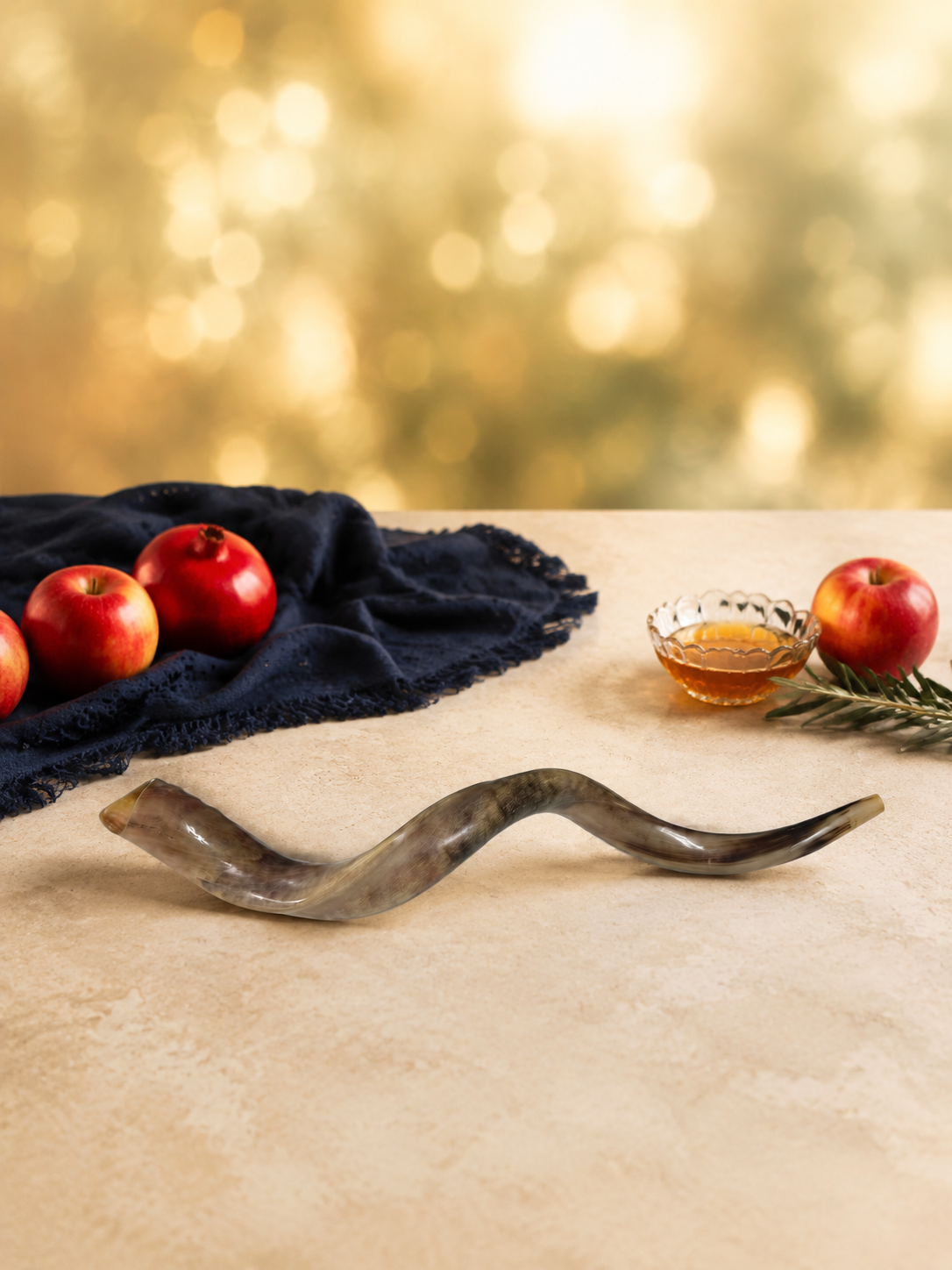 80 cm Yemenite kudu shofar staged with apples pomegranate and honey for Rosh Hashanah