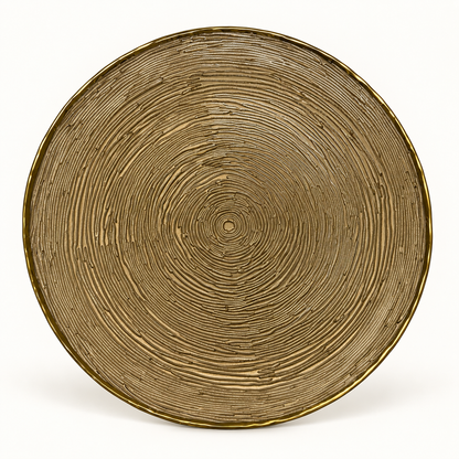 Amber glass serving plate with tree-ring texture and gold rim on a white background
