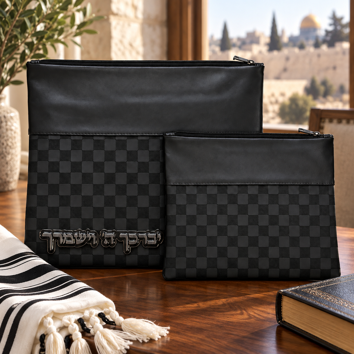 Black checkerboard tallit and tefillin bag set displayed with a tallit and siddur