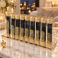 Black crystal Hanukkah menorah with gold cityscape details displayed on a marble console in a warmly lit home