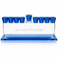 Blue crystal Hanukkah menorah with nine cobalt-blue cups and Hebrew engraving, front view