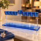 Blue crystal Hanukkah menorah displayed on a marble console in a warm home setting