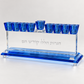 Three-quarter front view of crystal menorah with cobalt-blue cups and beveled blue base