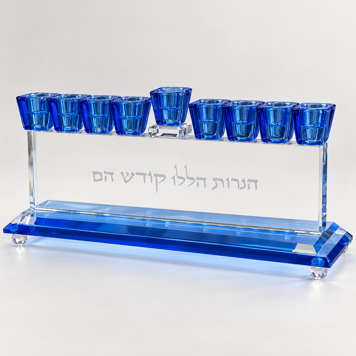 Three-quarter front view of crystal menorah with cobalt-blue cups and beveled blue base
