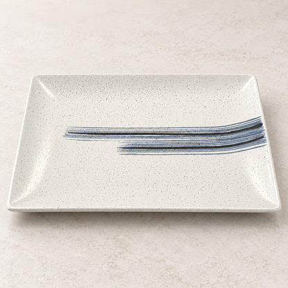 Ivory speckled ceramic serving platter with blue and black brushstroke design
