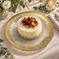 Clear glass serving plate with gold border styled with cake and fruit