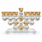 Crystal menorah with amber oil-cup holders and faceted clear and champagne spheres, front view