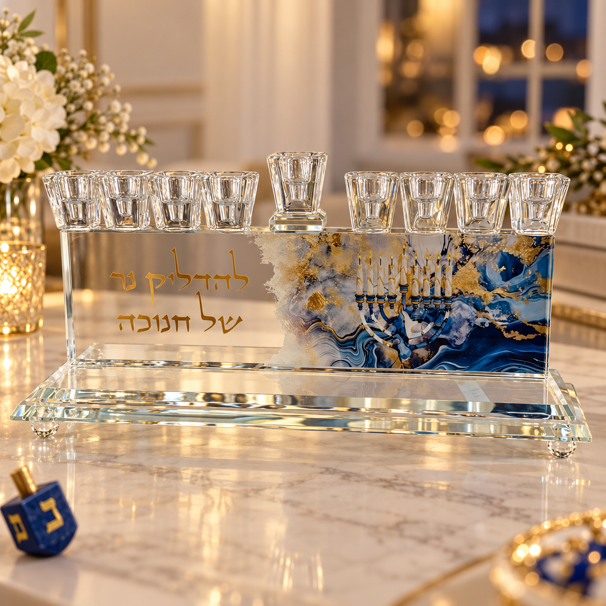 Crystal Hanukkah menorah with blue and gold artwork and Hebrew inscription displayed on a marble console in a warmly lit home