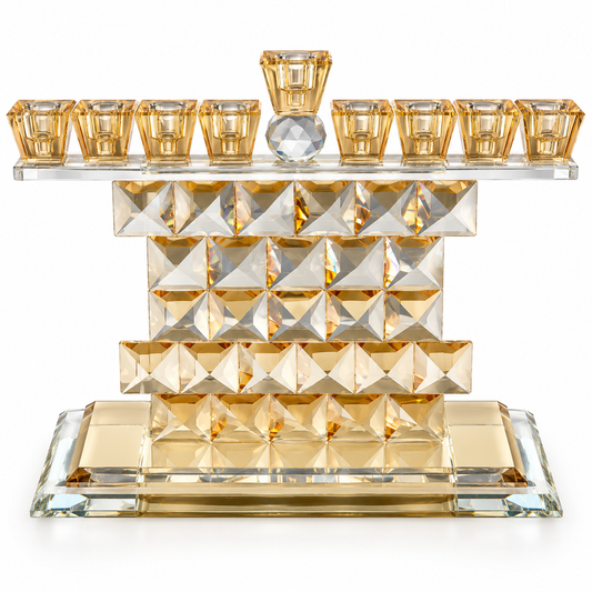 Gold geometric crystal Hanukkah menorah with amber-gold glass holders, faceted crystal body and a raised central shamash on a white background