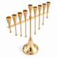 Gold-tone menorah for oil cups with nine tapered holders and eight hanging ball details, angled view