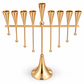 Gold-tone menorah for oil cups with nine tapered holders and eight hanging ball details, elevated front view