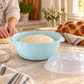 Light blue Hafrashat Challah bowl with risen dough in a home kitchen