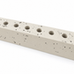 Close-up of ivory concrete hanukkiah showing natural pores and round recessed holders