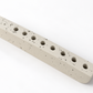 Ivory concrete hanukkiah viewed from above, showing nine recessed holders and textured surface