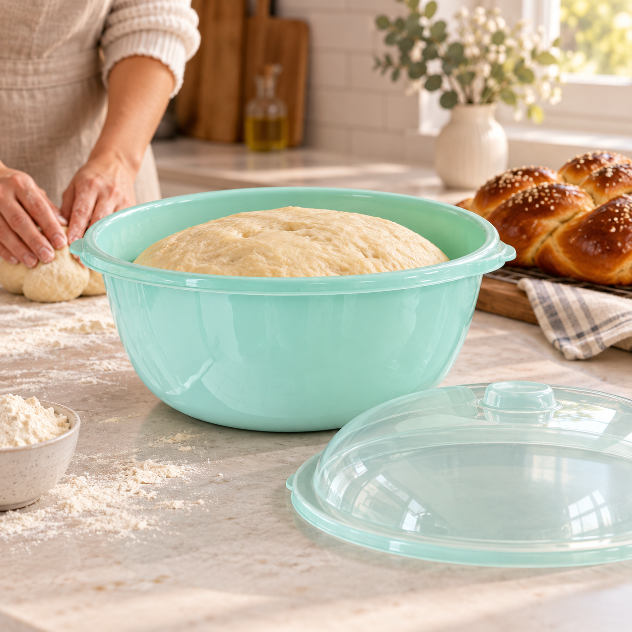 Large mint green Hafrashat Challah bowl with risen dough in a home kitchen