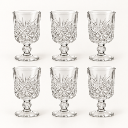 Six mini cut-glass wine goblets on a white background