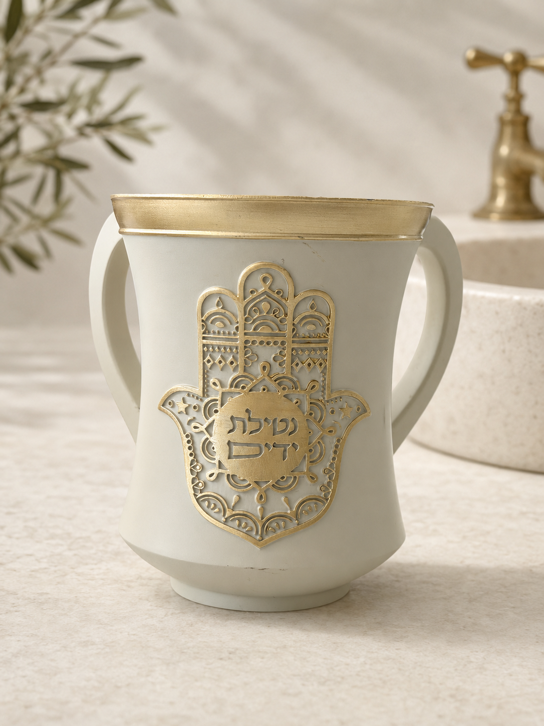 Ivory and gold polyresin Netilat Yadayim wash cup with ornate Hamsa emblem