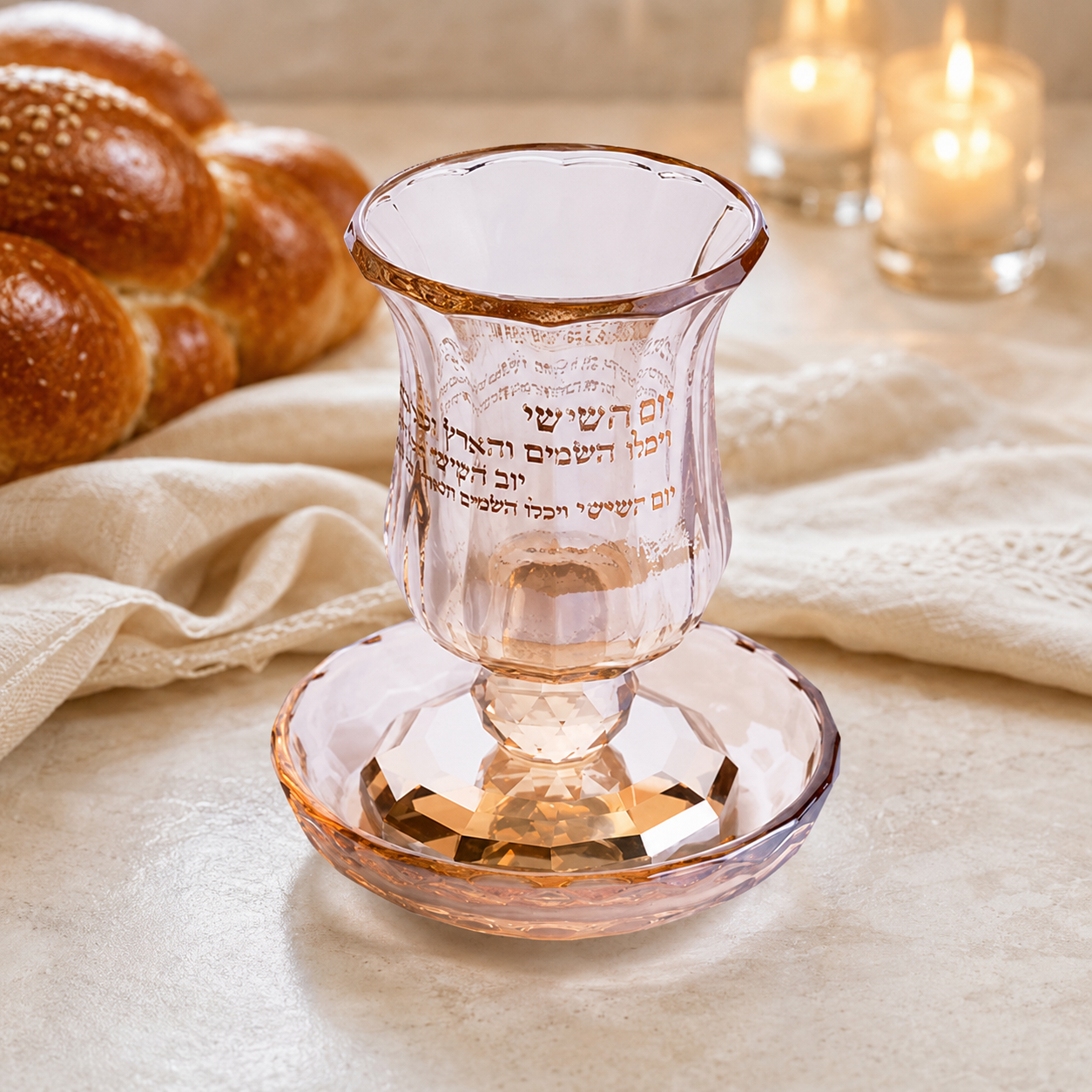 Rose crystal Kiddush cup and saucer staged on an elegant Shabbat table