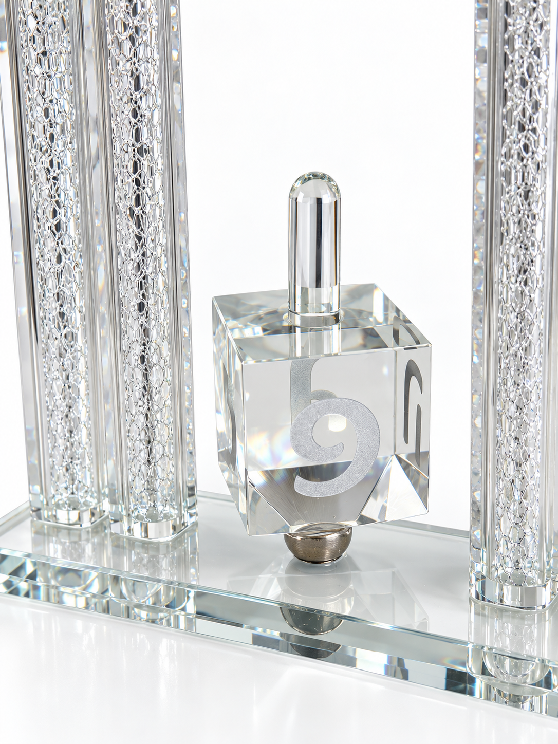 Close-up of the silver Hebrew lettering and crystal spinning dreidel