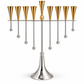 Silver and gold oil-cup menorah with gold tapered holders and a gold center accent, silver frame, hanging ball details and pedestal, front view
