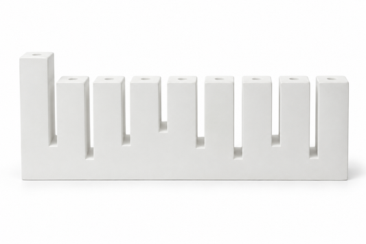 White concrete Hanukkah menorah with nine rectangular holders and raised left shamash, front view