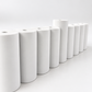 Close-up of matte white concrete menorah cylinders and raised center shamash