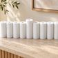 White concrete Hanukkah menorah displayed on a stone console in a neutral home