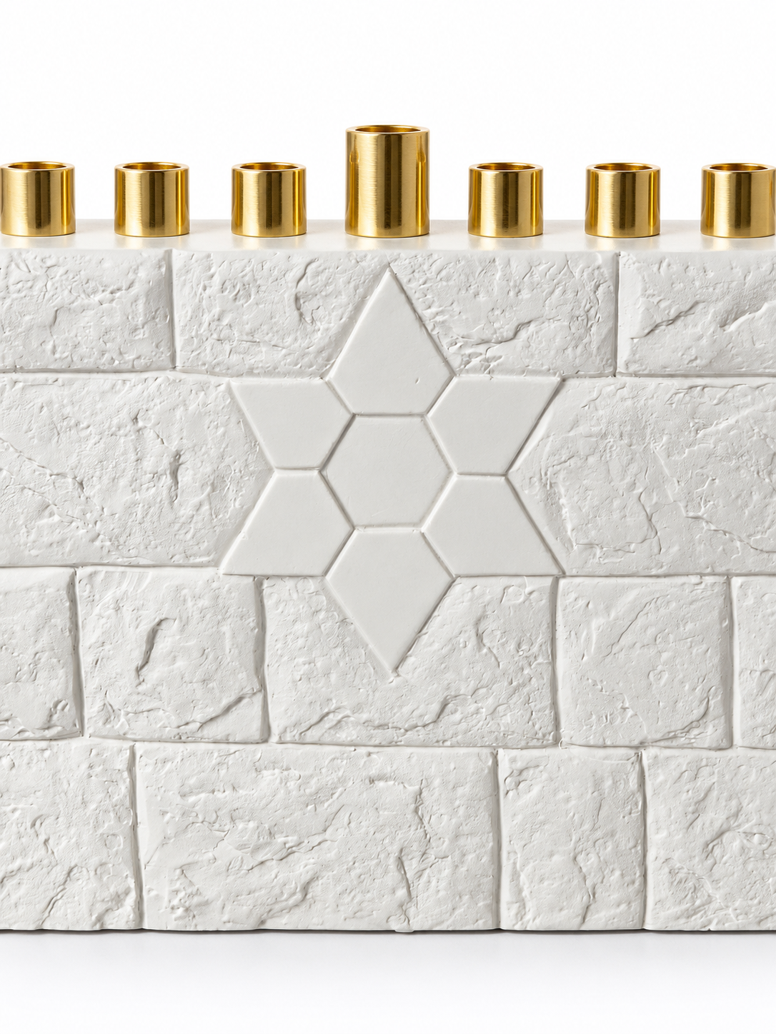 Close-up of the white Star of David motif, concrete brick texture, and taller center gold-tone shamash holder.