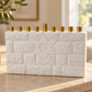 White concrete Star of David menorah with gold-tone candle holders displayed on a neutral stone console in a bright home.