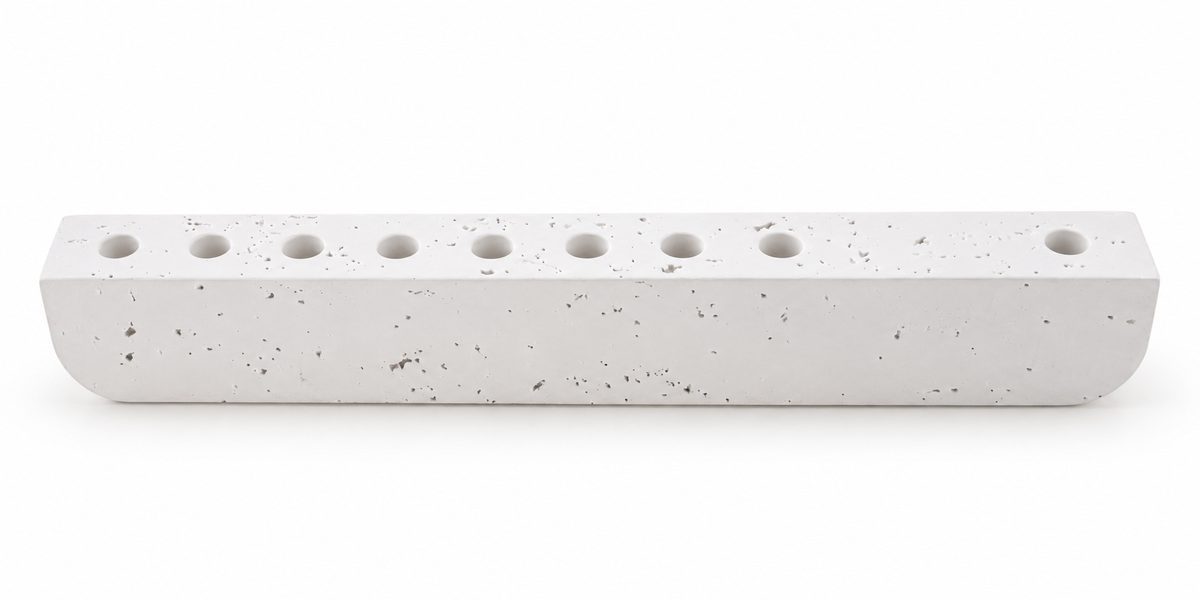 White textured concrete hanukkiah with nine recessed holders, front view