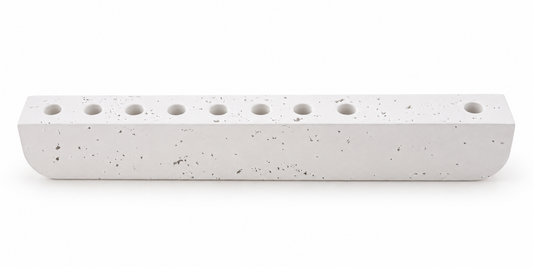 White textured concrete hanukkiah with nine recessed holders, front view