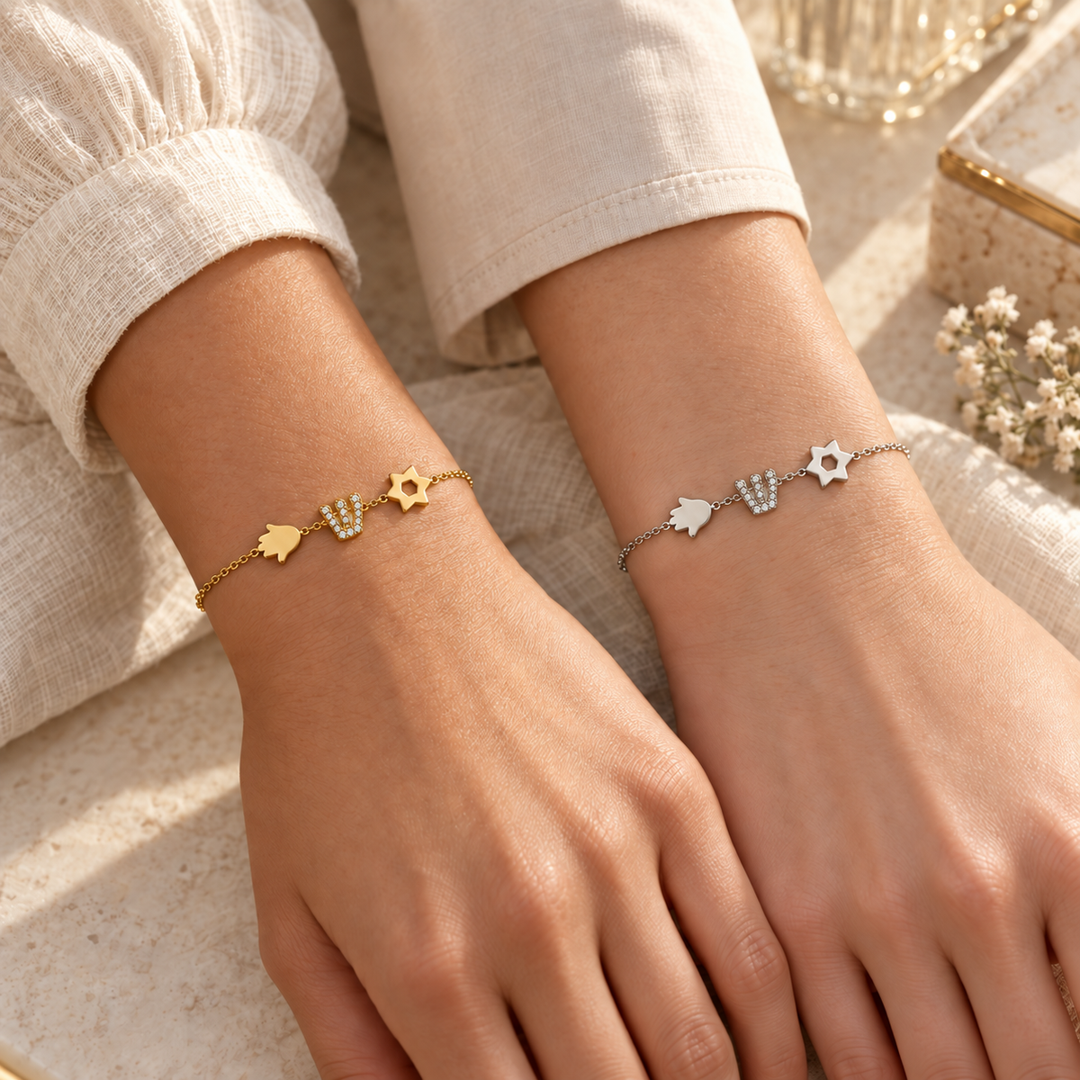 Women wearing gold and silver Hamsa, Shin, and Star of David bracelets