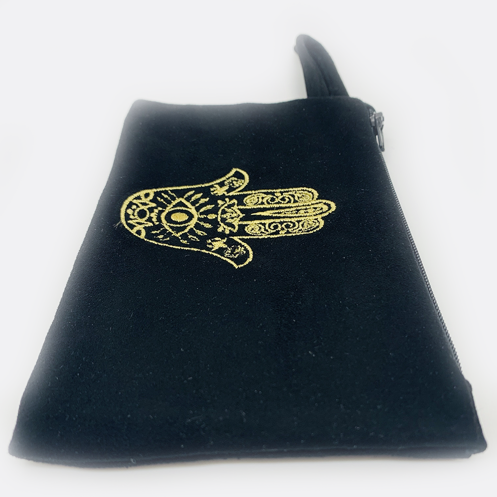 Embroidered hamsa Suede black or white bag zipper closure. Satin lining.